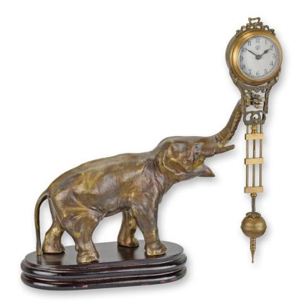 A TABLE CLOCK MYSTERIEUSE HELT BY AN ELEPHANT