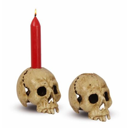 A CAST IRON SKULL CANDLE HOLDER, OLD WHITE
