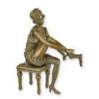 Bronzefigur Frau, Frauenfigur, A BRONZE SCULPTURE OF A WOMAN PUTTING ON PANTIES