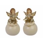 Paar Porzellanengel auf Ball, A PAIR OF PORCELAIN ANGELS ON BALL