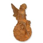 Gusseisenfigur Elfe auf Blumenball, rostfarben, A RUSTY CAST IRON FIGURINE OF A FAIRY SITTING ON BALL